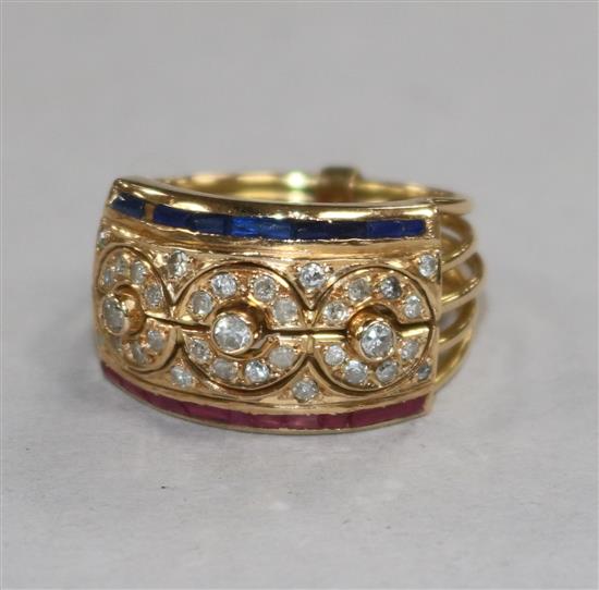 A Middle Eastern yellow metal multi shank ruby, diamond and sapphire puzzle ring, size M.